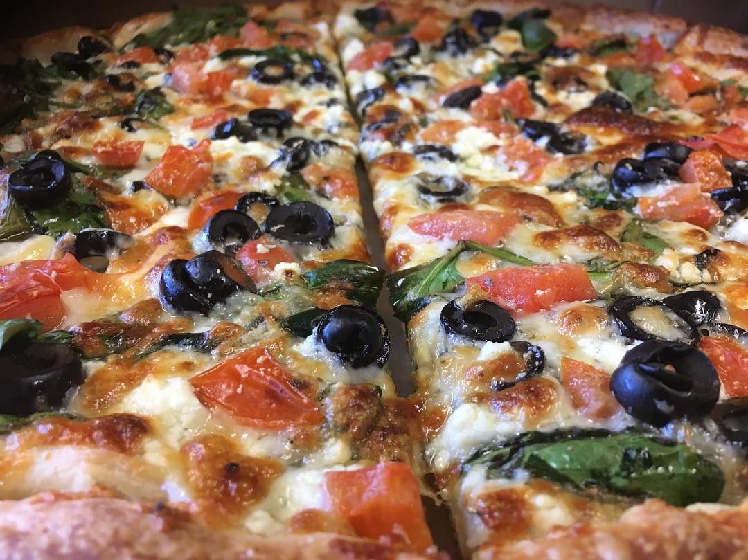 Greek pizza with olives and tomatoes